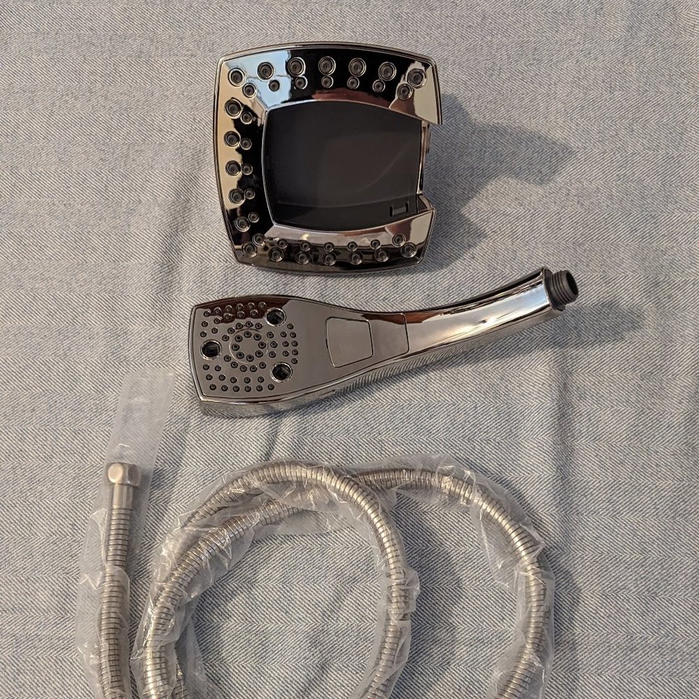 Delta chrome dual shower head with handheld sprayer built in, new in box.